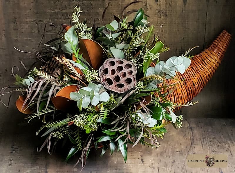 Autumn floral arrangement with rich orange, burgundy, and green seasonal greenery, handcrafted by Harmonic Blooms in Glastonbury, CT.